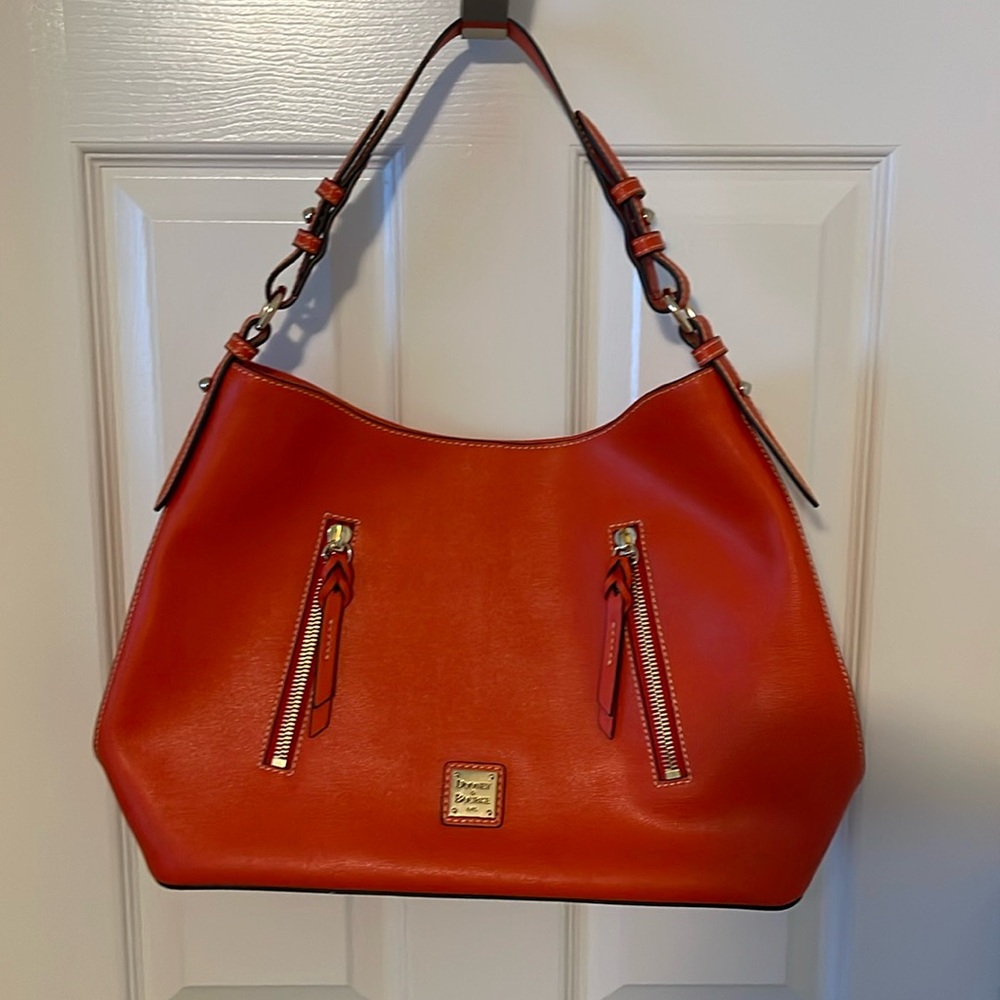 A RED (tomato) Dooney & Bourke bag.